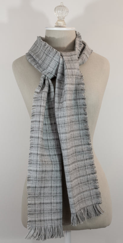 A gray tartan plaid flannel scarf with fringe, displayed on a mannequin.
Photo by Karen King  [additional_image_link]