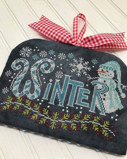Decorative pouch with 'Winter' text and snowman design, tied with a red and white checkered ribbon.
Photo by Handsondesign.com [additional_image_link]