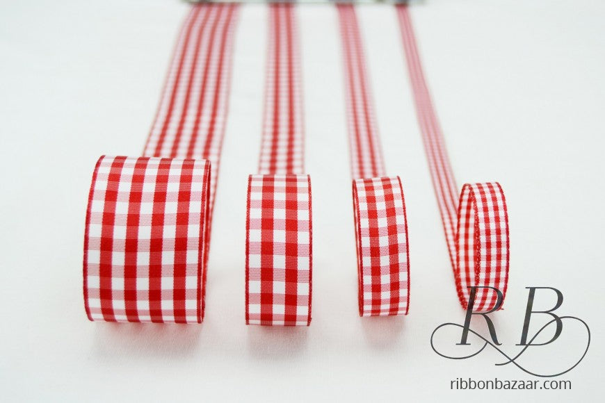 Four rolls of red and white gingham ribbon arranged vertically on a white background, with a watermark logo for 'ribbonbazaar.com' in the bottom right corner.
Photo by Handsondesign.com [additional_image_link]