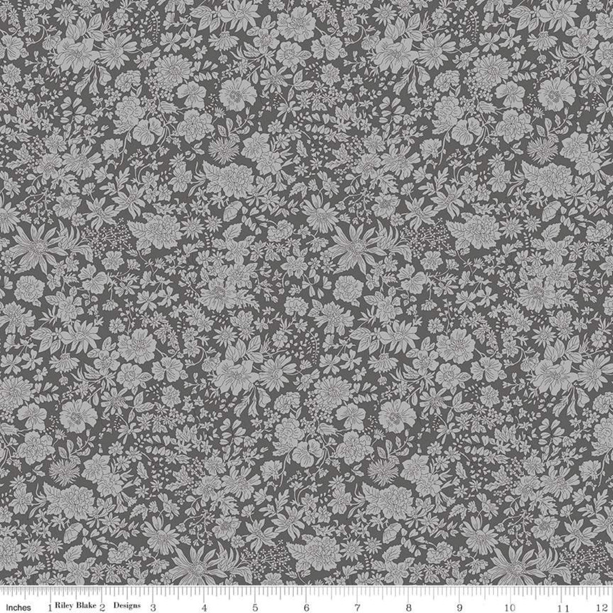 Gray fabric with a dense white floral and botanical pattern, shown flat with a ruler along the bottom edge indicating scale.
Photo by RileyBlakeDesigns.com [image_link]
