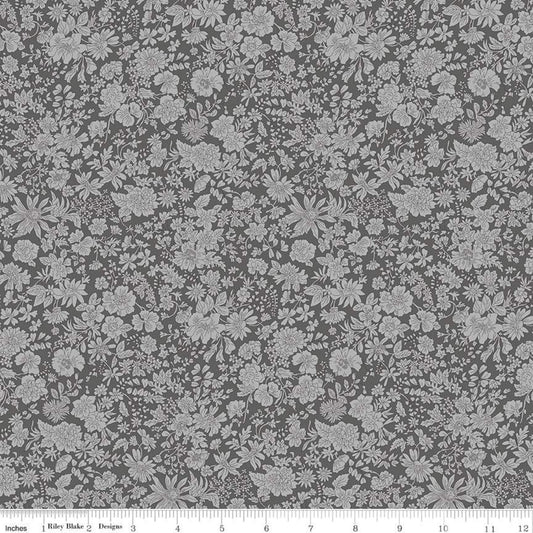 Gray fabric with a dense white floral and botanical pattern, shown flat with a ruler along the bottom edge indicating scale.
Photo by RileyBlakeDesigns.com [image_link]