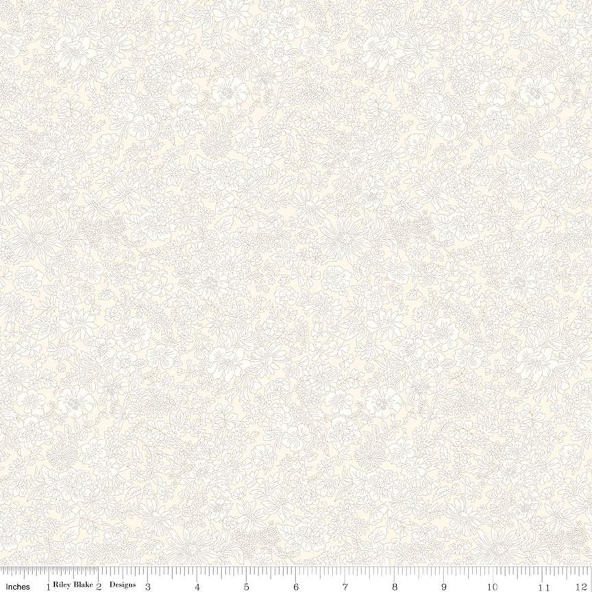 A close-up of a light cream and off-white damask patterned fabric with a ruler scale along the bottom edge showing measurements in inches.
Photo by RileyBlakeDesigns.com [image_link]