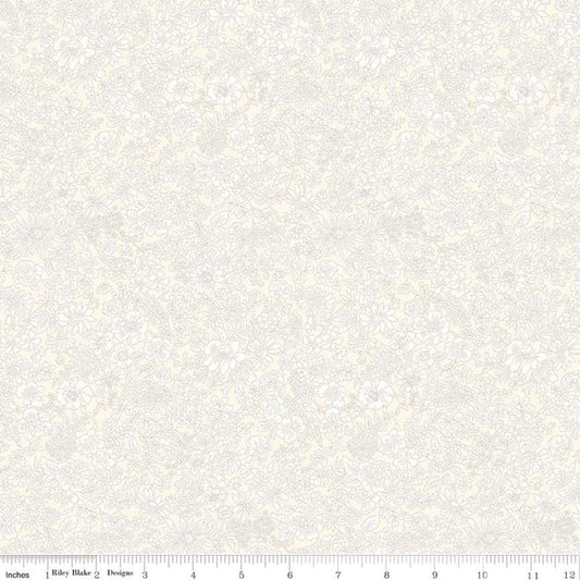 A close-up of a light cream and off-white damask patterned fabric with a ruler scale along the bottom edge showing measurements in inches.
Photo by RileyBlakeDesigns.com [image_link]