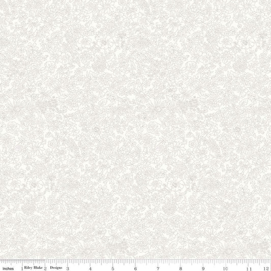 A close-up of a light cream fabric with a subtle, tonal damask or floral scroll pattern, featuring a white ruler scale at the bottom indicating 12 inches.
Photo by RileyBlakeDesigns.com [image_link]