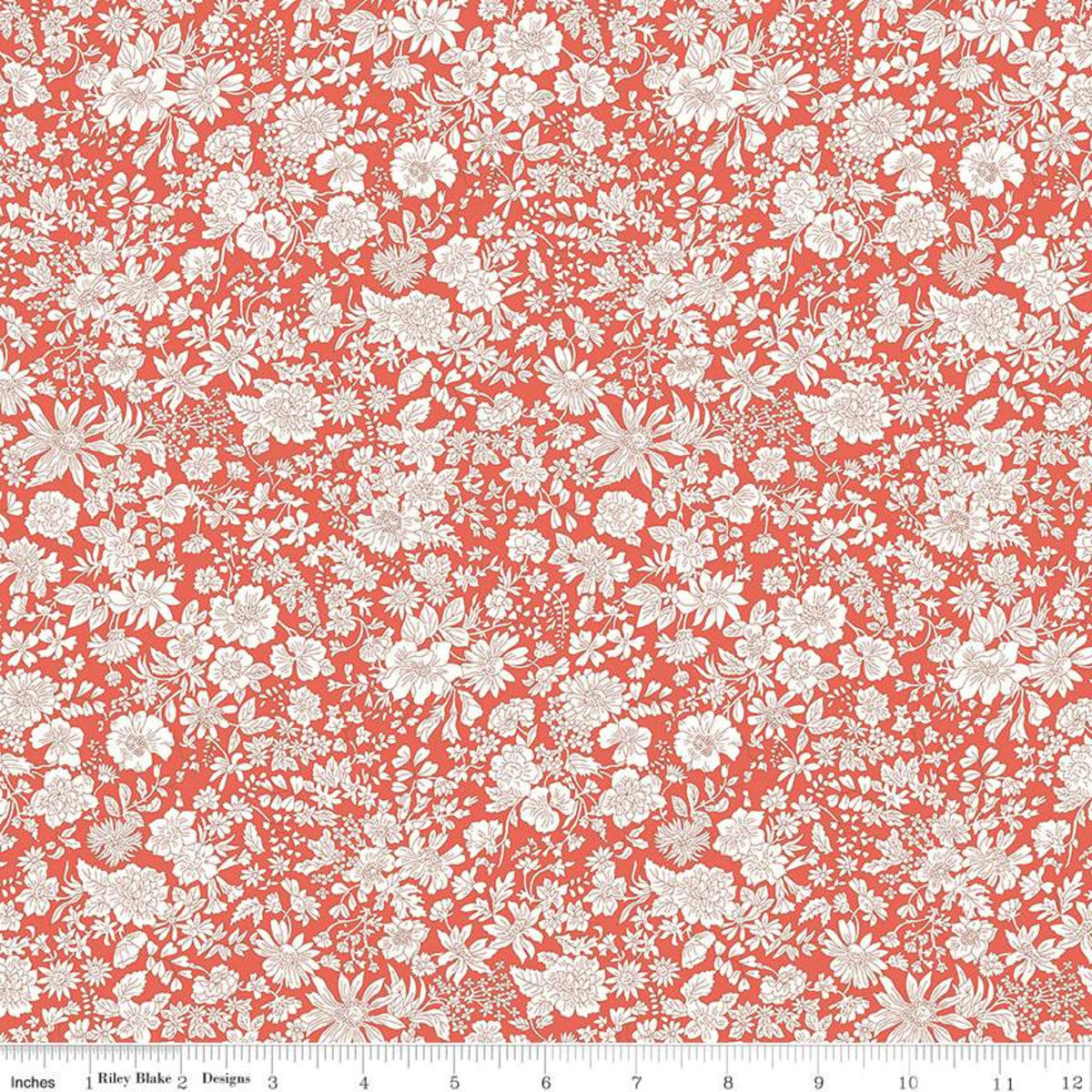 A close-up of a repeating floral fabric pattern in coral red and off-white, with a ruler along the bottom edge showing scale. The pattern features dense small flowers, leaves, and stems.
Photo by RileyBlakeDesigns.com [image_link]