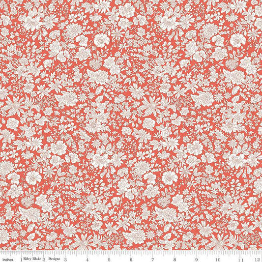 A close-up of a repeating floral fabric pattern in coral red and off-white, with a ruler along the bottom edge showing scale. The pattern features dense small flowers, leaves, and stems.
Photo by RileyBlakeDesigns.com [image_link]