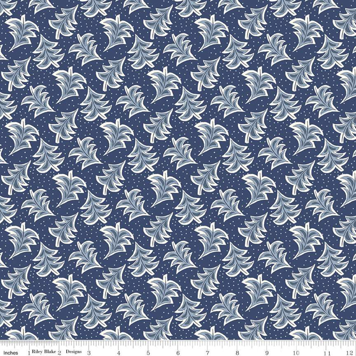 A repeating fabric pattern featuring stylized white and light blue leaf motifs on a dark navy blue background with small white dots, shown with a ruler along the bottom edge.
Photo by RileyBlakeDesigns.com [image_link]
