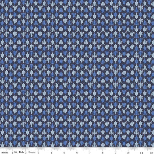 A close-up of a repeating fabric or wallpaper pattern showing small stylized leaf or pine-like motifs in light blue, medium blue, and white on a dark navy background, with a ruler strip along the bottom edge.
Photo by RileyBlakeDesigns.com [image_link]