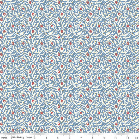 A close-up of a fabric pattern featuring a light blue background with dense white leafy vines and small red circular floral accents, with a ruler along the bottom edge showing scale.
Photo by RileyBlakeDesigns.com [image_link]