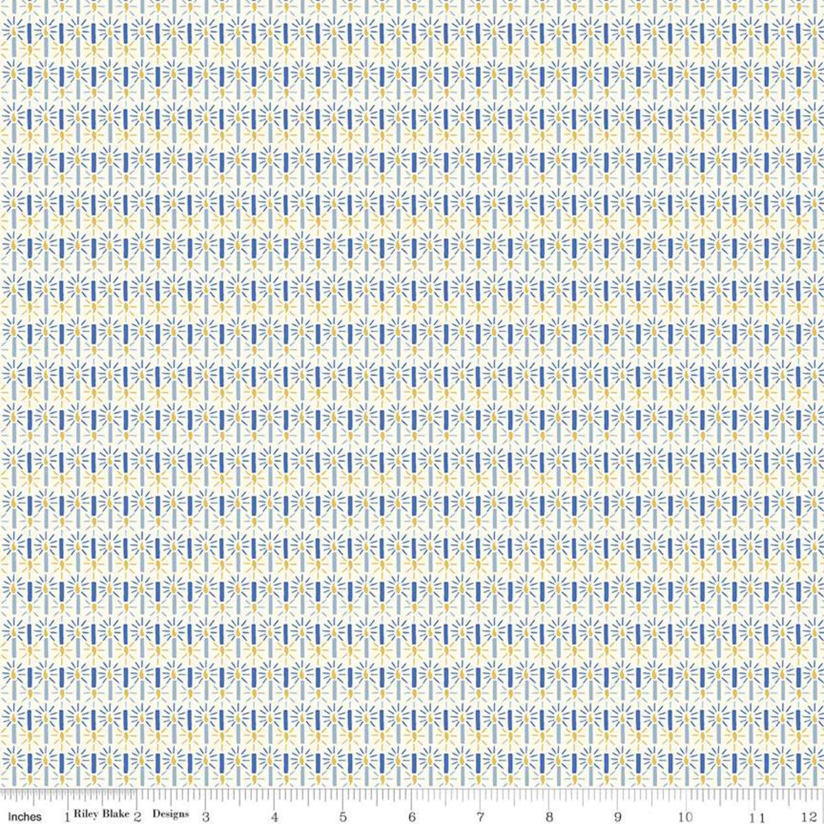 A repeating fabric pattern featuring vertical columns of small blue and yellow stylized floral or leaf motifs on a white background, with a ruler scale and the text 'Riley Blake Designs' visible along the bottom edge.
Photo by RileyBlakeDesigns.com [image_link]