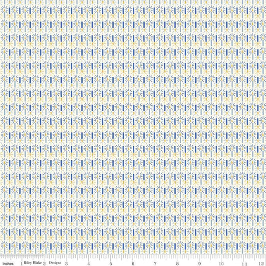 A repeating fabric pattern featuring vertical columns of small blue and yellow stylized floral or leaf motifs on a white background, with a ruler scale and the text 'Riley Blake Designs' visible along the bottom edge.
Photo by RileyBlakeDesigns.com [image_link]