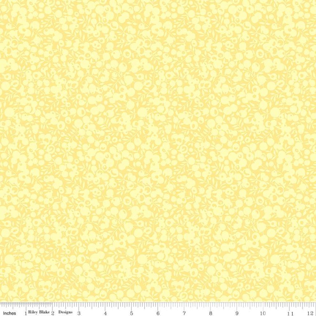 A close-up of a pale yellow fabric or material swatch with a repeating light floral pattern, plus a ruler strip along the bottom edge showing measurements.
Photo by RileyBlakeDesigns.com [image_link]