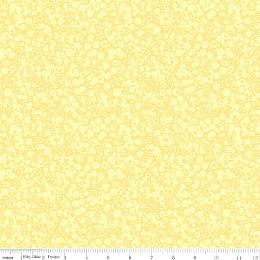 A close-up of a pale yellow fabric or material swatch with a repeating light floral pattern, plus a ruler strip along the bottom edge showing measurements.
Photo by RileyBlakeDesigns.com [image_link]