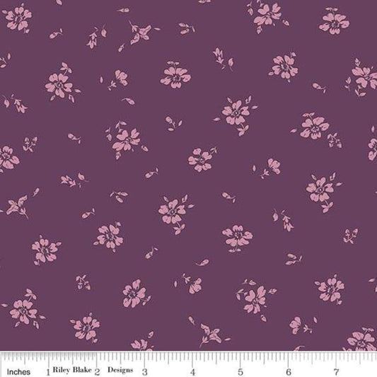 A yardstick measuring fabric with a floral pattern consisting of small pink flowers on a purple background.
Photo by RileyBlakeDesigns.com [image_link]