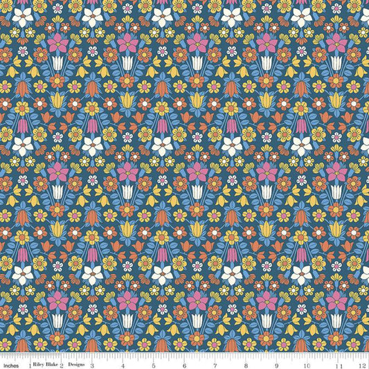 A fabric from the Flower Show Midsummer Collection by Liberty Fabrics, featuring a detailed floral pattern with a variety of flowers in shades of blue, red, and white, and a visible measuring scale along the edge.
Photo by RileyBlakeDesigns.com [image_link]