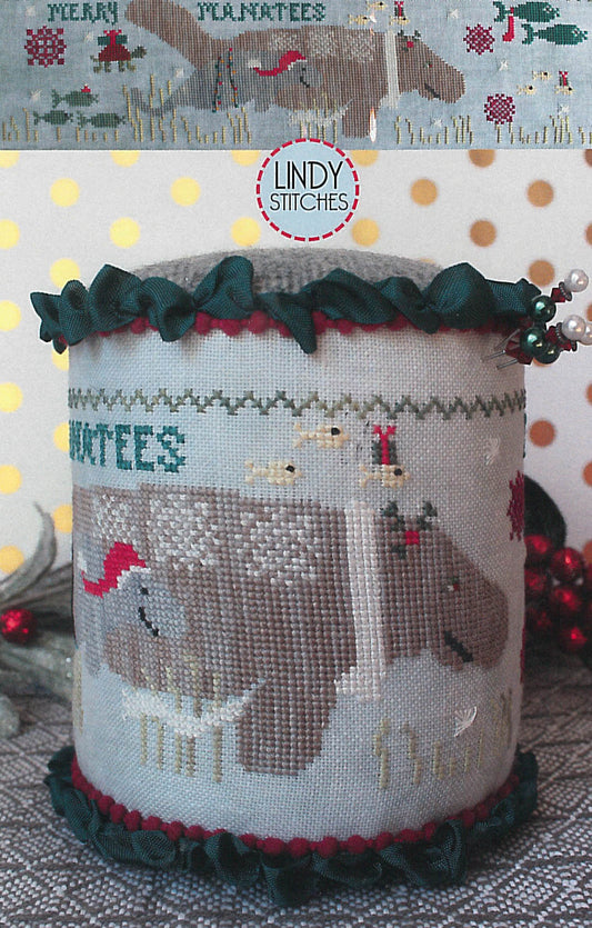 A cross stitch pattern drum kit depicting manatees in a Christmas theme, with holiday decorations and a Santa hat, from Lindy Stitches.
Photo by Lindy Stitches [image_link]