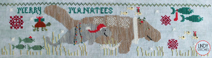 A cross stitch pattern drum kit depicting manatees in a Christmas theme, with holiday decorations and a Santa hat, from Lindy Stitches.
Photo by Lindy Stitches [additional_image_link]