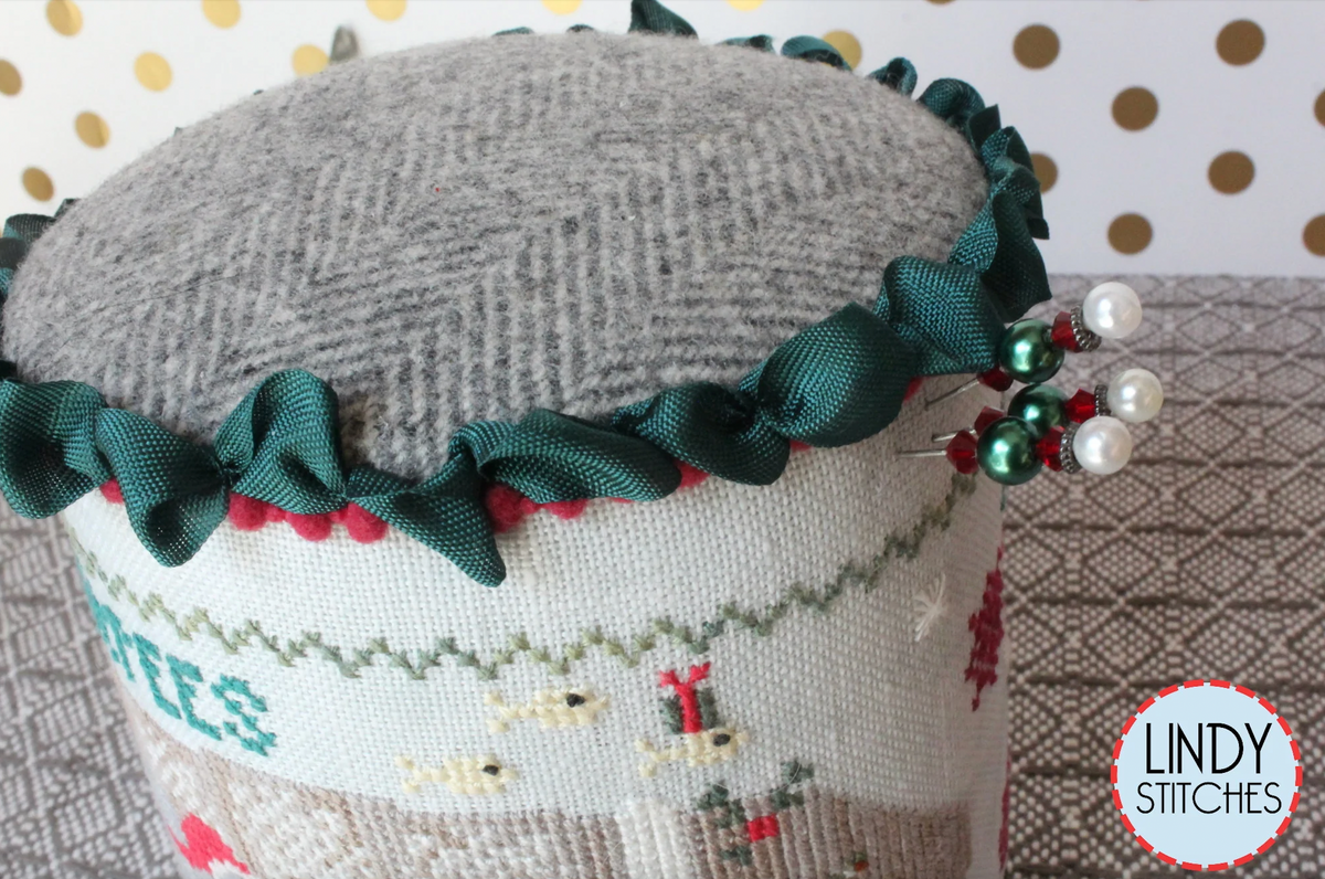 A cross stitch pattern drum kit depicting manatees in a Christmas theme, with holiday decorations and a Santa hat, from Lindy Stitches.
Photo by Lindy Stitches [additional_image_link]