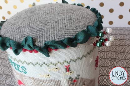 A cross stitch pattern drum kit depicting manatees in a Christmas theme, with holiday decorations and a Santa hat, from Lindy Stitches.
Photo by Lindy Stitches [additional_image_link]