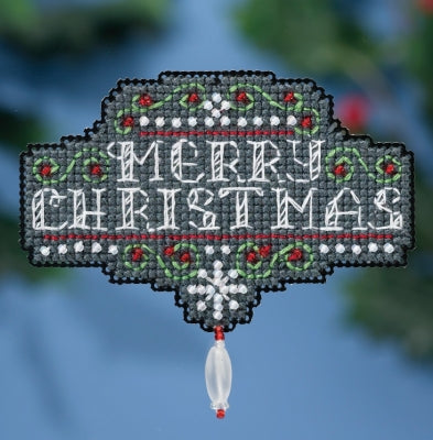 A chalkboard Christmas ornament in progress, with black background and white text saying 'Merry Christmas' surrounded by green and red beads.
Photo by Mill Hill [image_link]