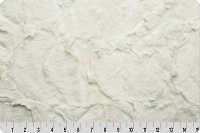 A close-up of a white textured fabric with a crinkled or shaggy surface, shown with a measuring ruler along the bottom edge to indicate scale.
Photo by Shannon Fabrics [additional_image_link]