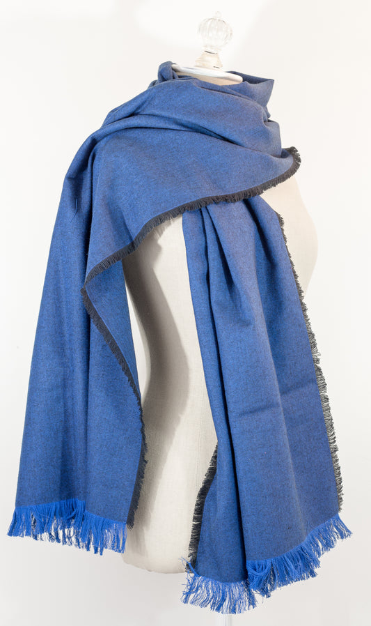 Navy blue herringbone flannel blanket scarf displayed on a mannequin, with fringe detailing and a kilt pin.
Photo by Karen King  [image_link]