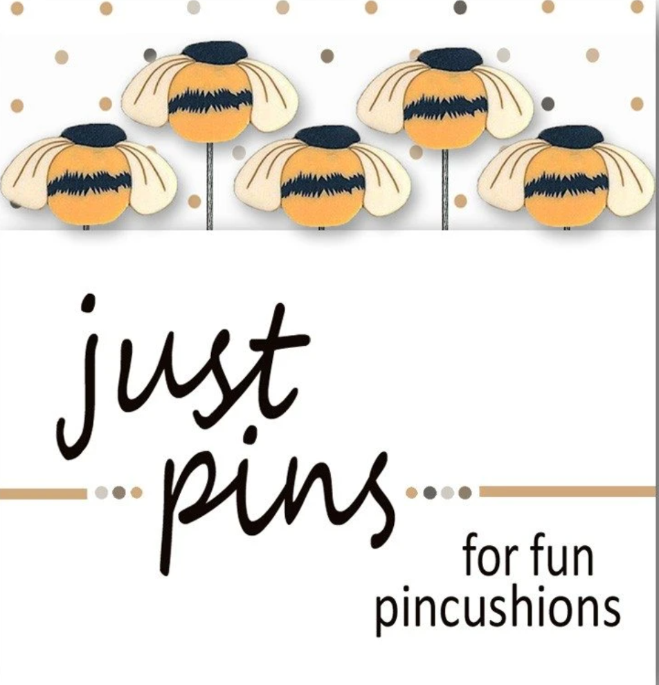 A graphic design featuring four cartoon bumblebees with cream wings, black and orange bodies, and black stings on a white background with gold polka dots. Below the bees, the text reads 'just pins for fun pincushions' in black lettering.
Photo by HandsOnDesign.biz [additional_image_link]