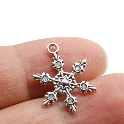 Silver snowflake charm.
[additional_image_link]
