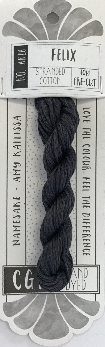 A packaged pre-cut embroidery thread bundle labeled 'FELIX' on a white and gray card. The thread is a very dark charcoal gray, almost black, and is shown twisted into a braided bundle.
Photo by cottagegardenthread.com [additional_image_link]