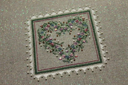 A cross stitch embroidery kit packaging from The Sweetheart Tree featuring a heart-shaped design with floral patterns.
Photo by The Sweetheart Tree [additional_image_link]