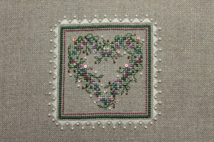 A cross stitch embroidery kit packaging from The Sweetheart Tree featuring a heart-shaped design with floral patterns.
Photo by The Sweetheart Tree [additional_image_link]