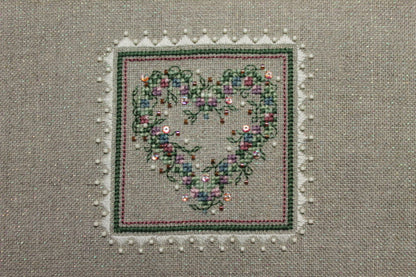 A cross stitch embroidery kit packaging from The Sweetheart Tree featuring a heart-shaped design with floral patterns.
Photo by The Sweetheart Tree [additional_image_link]