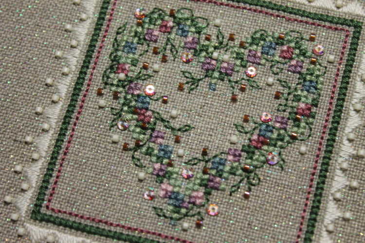 A cross stitch embroidery kit packaging from The Sweetheart Tree featuring a heart-shaped design with floral patterns.
Photo by The Sweetheart Tree [additional_image_link]