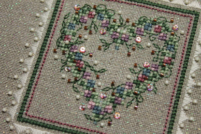 A cross stitch embroidery kit packaging from The Sweetheart Tree featuring a heart-shaped design with floral patterns.
Photo by The Sweetheart Tree [additional_image_link]