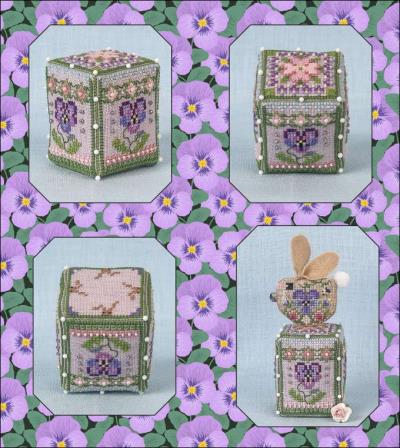 A collage showing four views of a decorative cross-stitch embroidery cube with floral and bunny motifs, set against a purple flower patterned background.
Photo by JustNan.com [image_link]