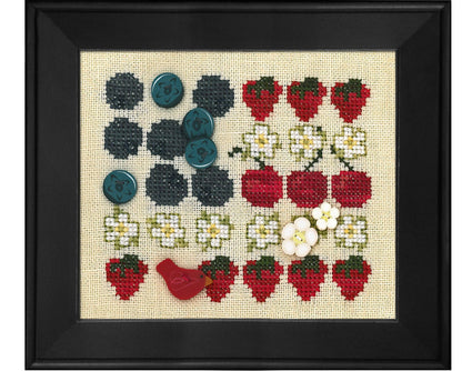 A framed cross-stitch sampler featuring rows of embroidered strawberries, blueberries, white flowers, and a small red bird on a beige fabric background, enclosed in a black frame.
Photo by JustAnotherButtonCompany.com [image_link]
