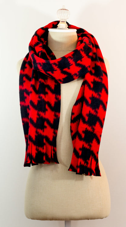 A scarf with a geometric houndstooth pattern in shades of red and black, displayed on a mannequin.
Photo by Karen King [additional_image_link]
