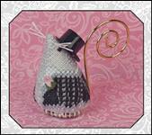A small decorative mouse with a black and white patterned body, a black top hat, and a gold spiral loop, shown against a pink patterned background with a gray border.
Photo by JustNan.com [additional_image_link]