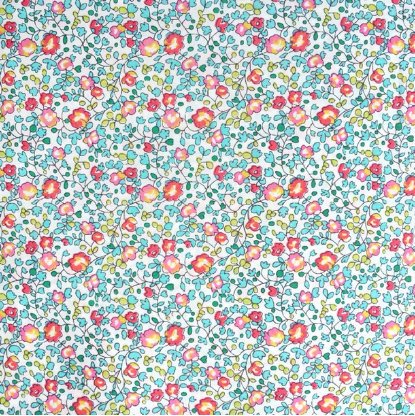 A close-up of a floral fabric pattern featuring small pink, red, yellow, and blue flowers with green leaves on a white background.
[additional_image_link]