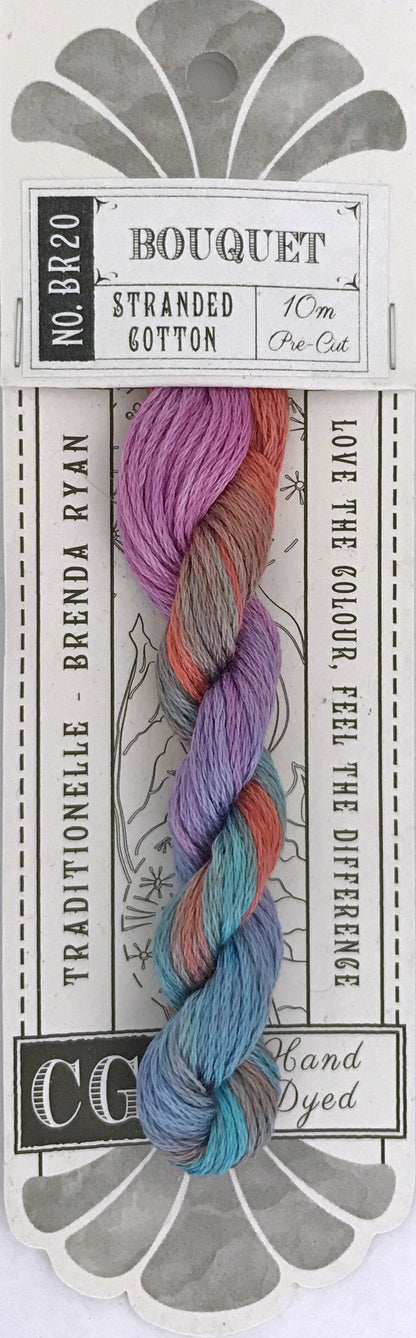 A packaged skein of bouquet stranded cotton yarn on a printed card. The yarn is multicolored with pastel purple, pink, orange, and blue tones, and the card reads 'Bouquet Stranded Cotton' and 'Traditionelle Brenda Ryan.
Photo by cottagegardenthread.com [additional_image_link]