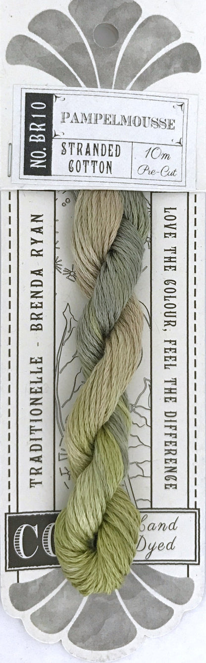 A packaged skein of Coe Fabrics 'Pampelmousse' stranded cotton embroidery floss. The floss is a variegated blend of sage green, olive green, and light beige.
Photo by cottagegardenthread.com [additional_image_link]