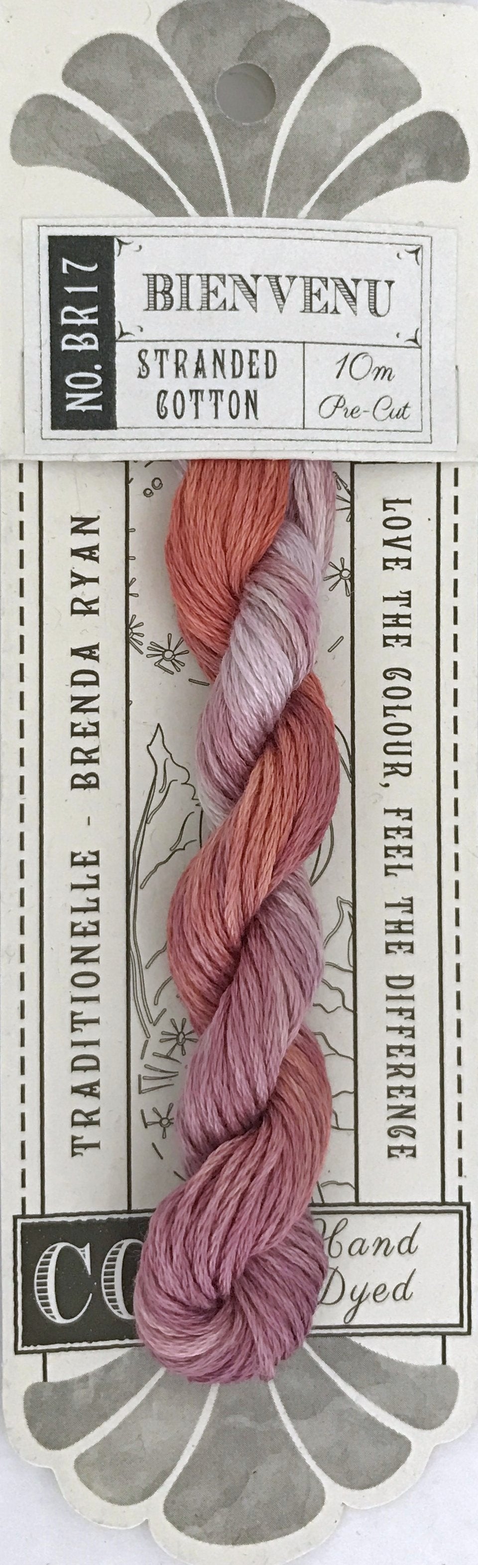 A skein of Coquette 'Bienvenu' stranded cotton embroidery floss in a dusty rose and mauve gradient, presented on its original white and gray cardboard packaging.
Photo by cottagegardenthread.com [additional_image_link]