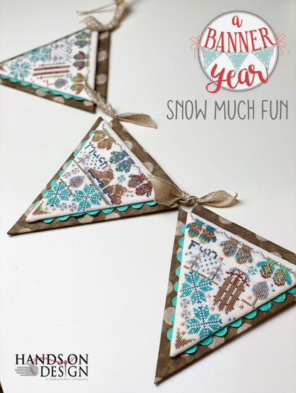 Three triangular fabric hanging banners with winter-themed printed patterns, tied with beige ribbons, displayed on a white background with the text 'a Banner Year SNOW MUCH FUN' and 'HANDS ON DESIGN'.
Photo by HandsOnDesign.biz [additional_image_link]