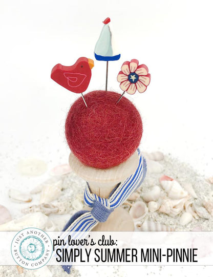A pincushion kit from Just Another Button Company, featuring a red felted wool ball, a wooden spool, and two seaworthy ribbons.
Photo by JustAnotherButtonCompany.com [additional_image_link]