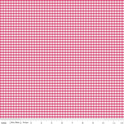 A close-up of a pink and white gingham checkered fabric pattern with a measuring ruler along the bottom edge showing inches and centimeters.
Photo by Rileyblakedesigns.com [additional_image_link]
