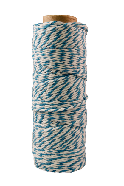 A spool of bakers twine made from twisted white and teal blue yarn, wound around a light brown cardboard core, shown against a plain white background.
Photo by May Arts [additional_image_link]