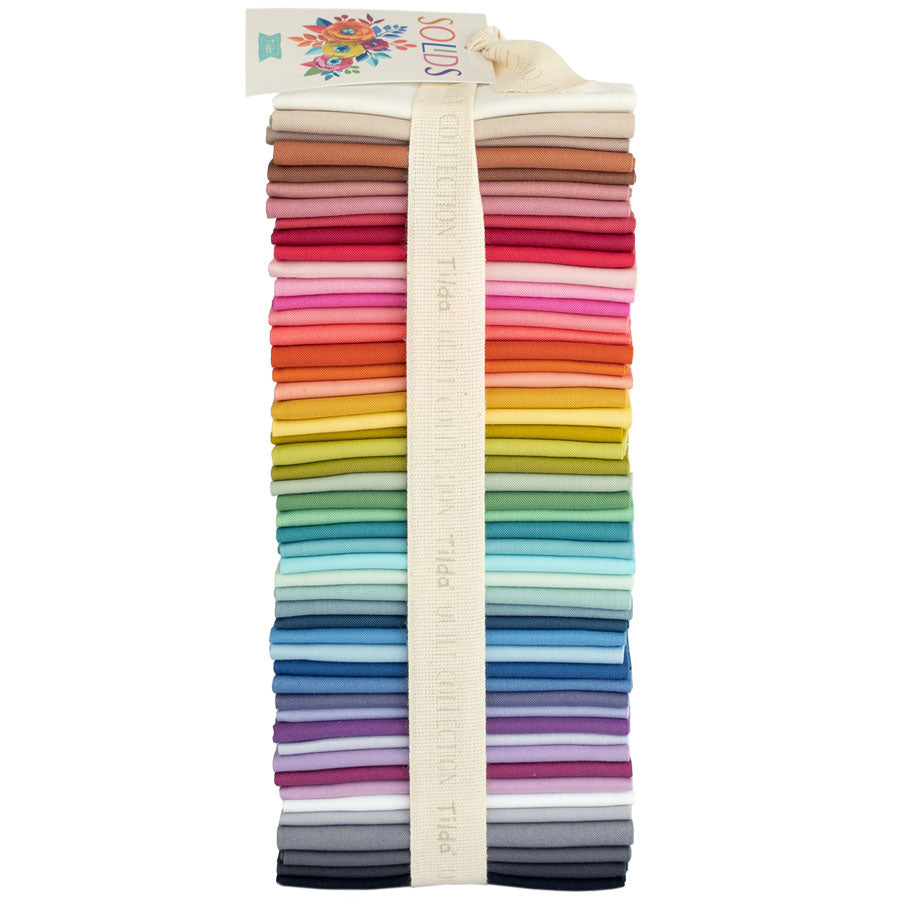 A bundle of Tilda Basics solid fat eighths fabrics in various colors, tied together with a label.
Photo by Tildafabrics.com [image_link]