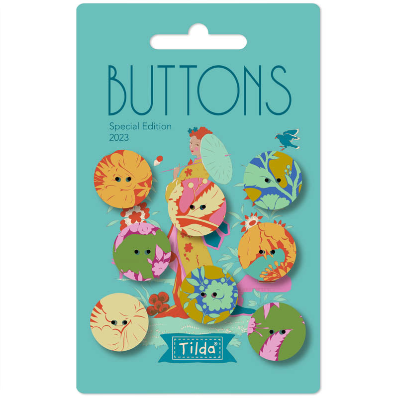 A package of 2023 Tilda Buttons Special Edition featuring colorful, whimsical cat-themed buttons on a teal card backing.
Photo by Tildafabrics.com [image_link]