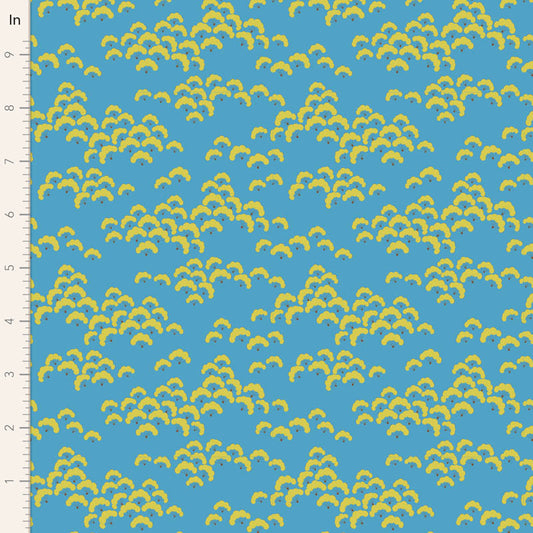 Fabric with yellow leaf pattern on a blue background, measured against a ruler.
Photo by Tildafabrics.com [image_link]