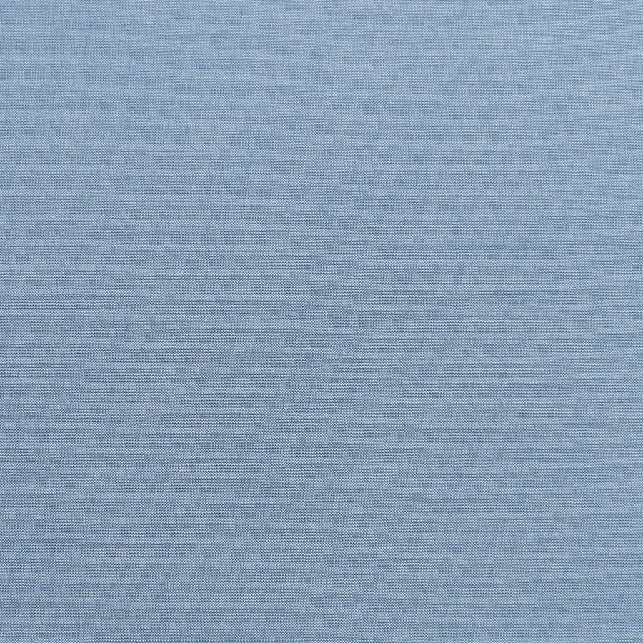 A swatch of Chambray Basics Blue fabric from Tilda Fabrics, displaying a woven texture in blue color.
Photo by Tildafabrics.com [image_link]